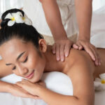 Asian woman are relaxing shoulder massage in the Spa Salon. Thai massage for health. Select focus hand of masseuse