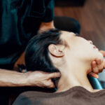 Mid adult woman receiving a head massage at a health spa